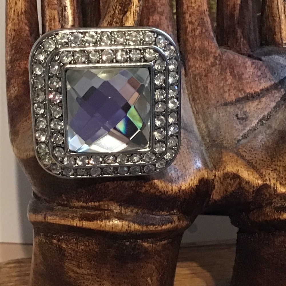 Statement costume jewelry ring, large facet cut surrounded by smaller crystals